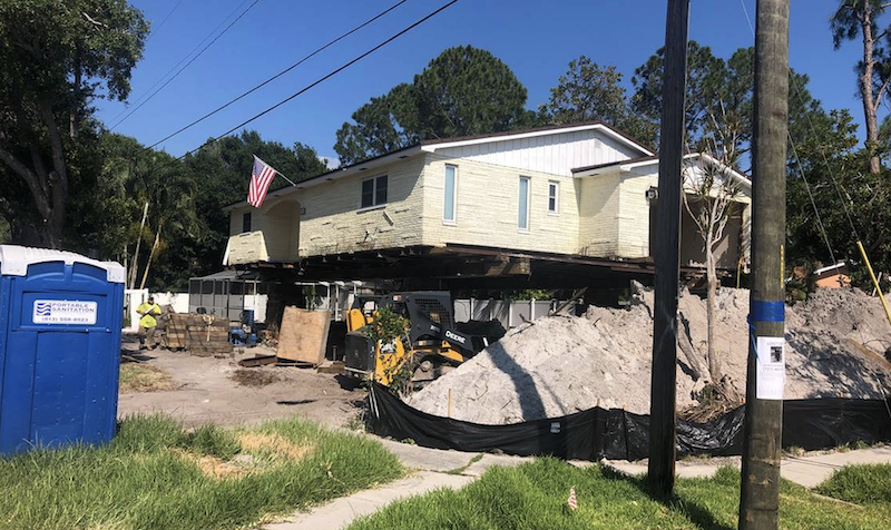 House lift in progress: raising the home's foundation in a flood-prone area