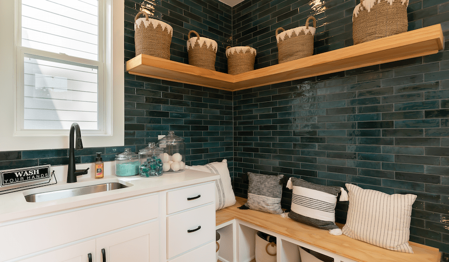 Family entry featuring laundry in the Barnaby home design by Dahlin Group Architecture Planning