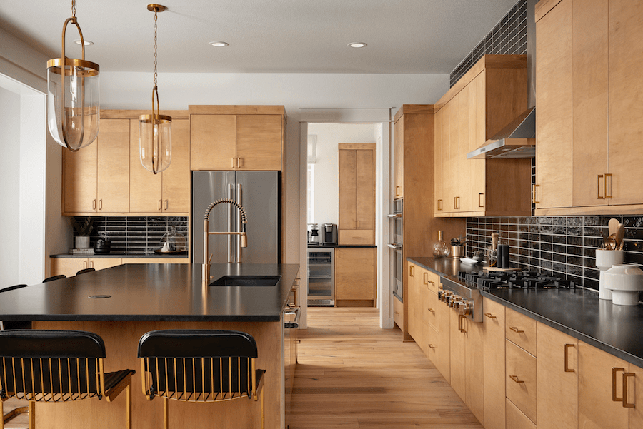 The kitchen and view to the back kitchen in DTJ Design's Westerly Premier Collection, Plan 6150 