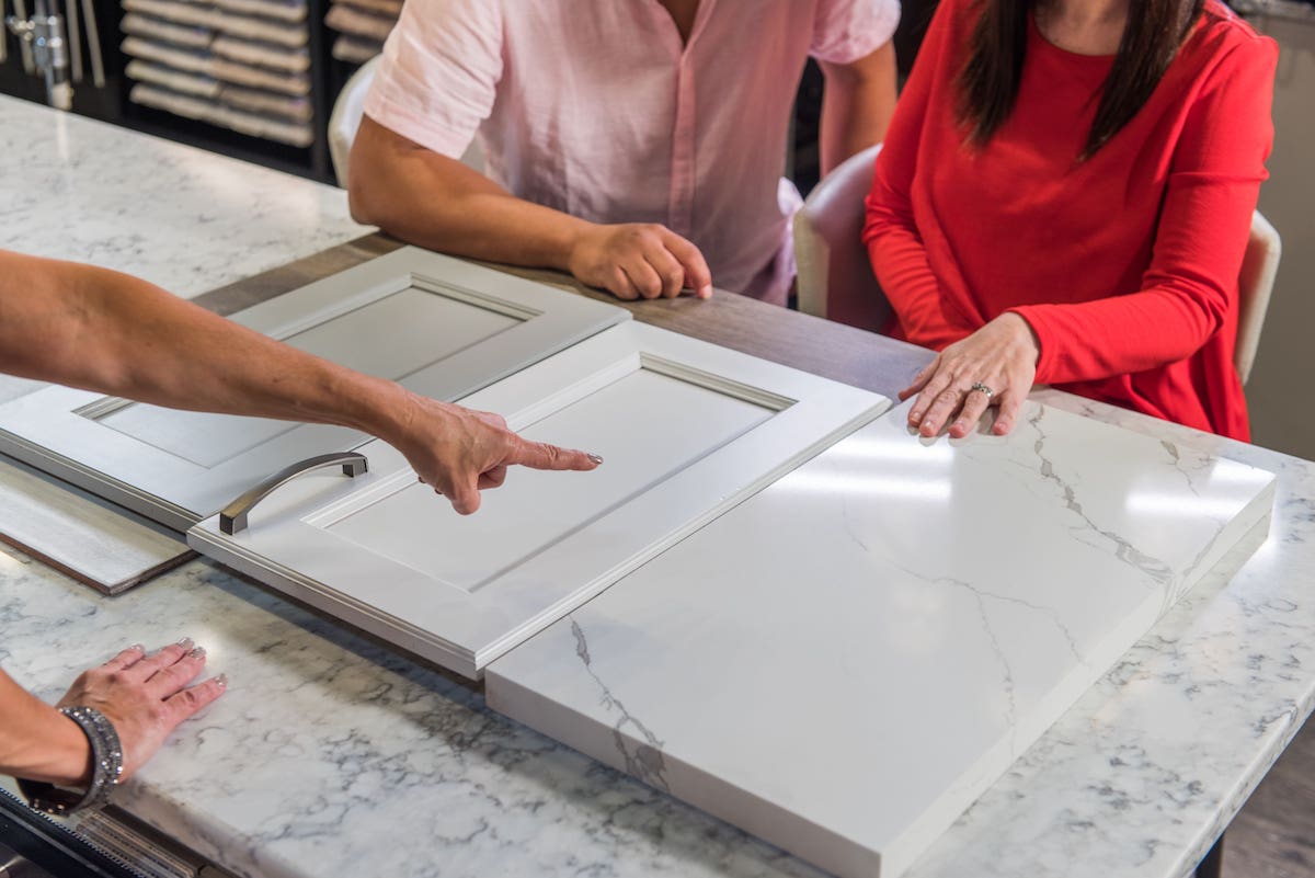 Home buyers selecting cabinet finishes