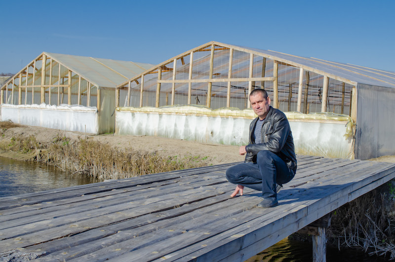 Man sitting in front of buildings in Ukraine