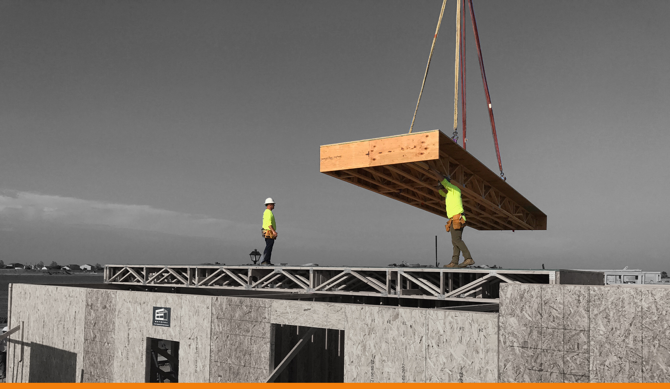 Entekra floor panels being lifted onto what will be a two-story, 2,800-square-foot house in Los Banos, Calif. Framing was completed in less than five days.