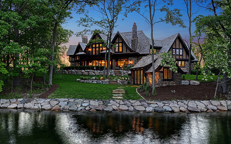 Exterior of custom Tudor home built using BuildTools construction management software.