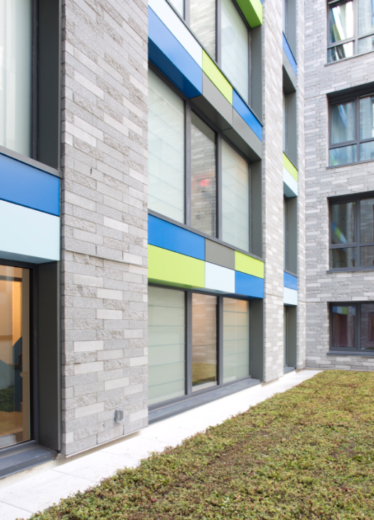 Triple pane windows and brick and panel exterior of Third Avenue building