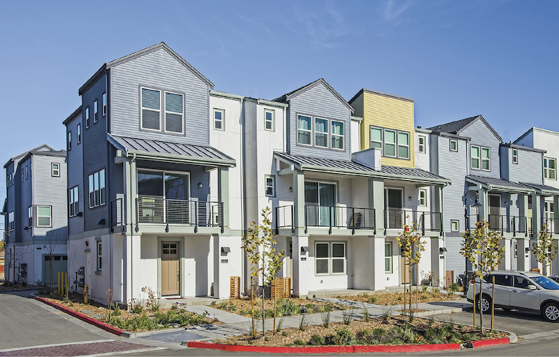 front facade of infill housing development Nova at the Vale, yellow-blue-gray color scheme