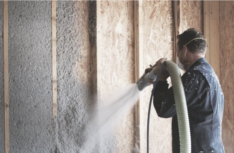 Installing cellulose insulation by spraying it into framed-wall cavities