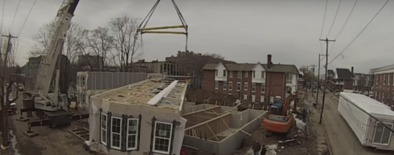 prefab home components being placed by crane