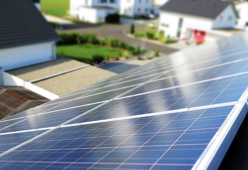 Solar panels on a house roof in a neighborhood that has a microgrid