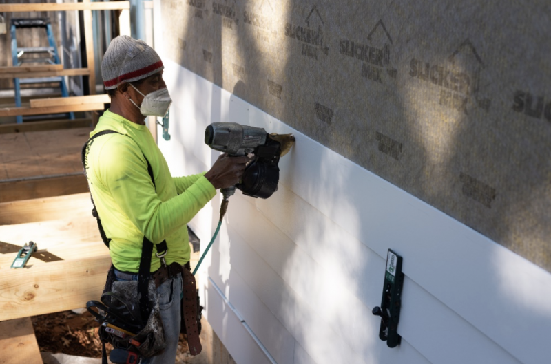 Installation of Allura’s 8-1/4” fiber cement lap siding in pre-finished color Snow ON THE SYMBI DUPLEX ONE 