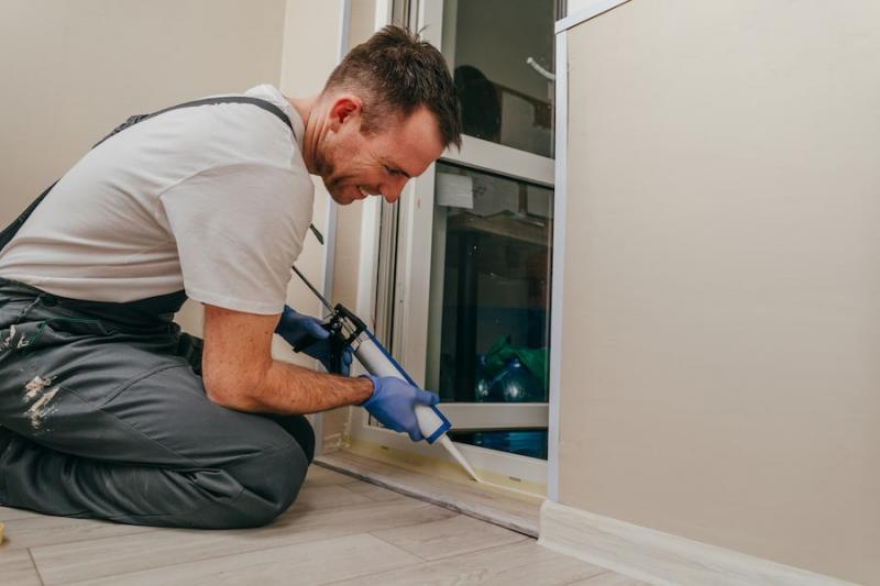 Flashing the door frame with adhesive