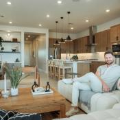 Interior designer Bobby Berk sitting in a Tri Pointe Homes model home