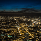 Light pollution shown in aerial nighttime view of a city and suburbs