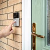 A person rings a smart door bell. 