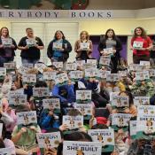 Students at Hazelwood Elementary in Edmonds, Wash. hold up their newly received "House That She Built" books