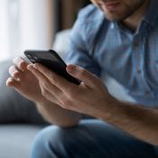 A man using apps on a cell phone