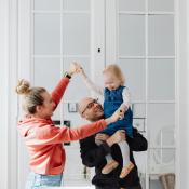 Couple with baby in clean house