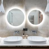 Twin bathroom mirrors with lighting around the back