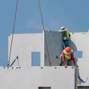 Workers installing concrete panels