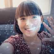 AI facial recognition for young woman raising her hand