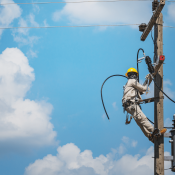 Lineman servicing electrical transformer despite shortage of electrical components  