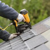 New asphalt shingles being installed on roof