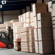 Man in warehouse transporting lumber