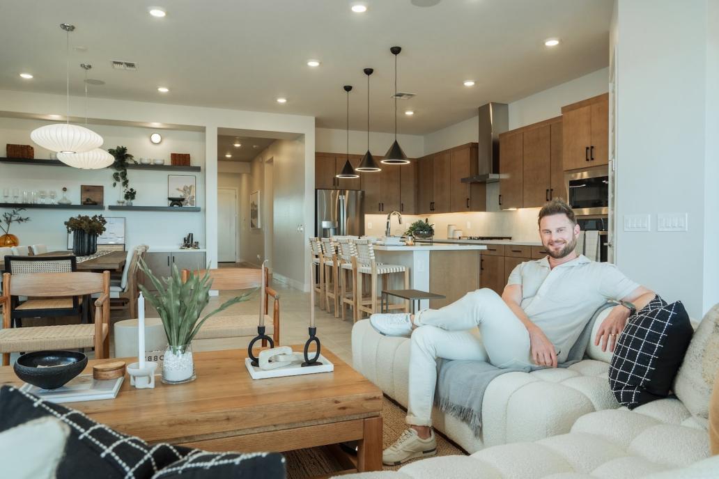 Interior designer Bobby Berk sitting in a Tri Pointe Homes model home