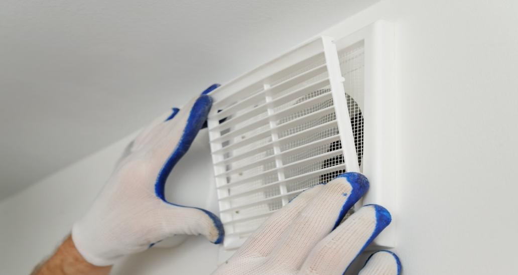 Worker installs ventilation grill