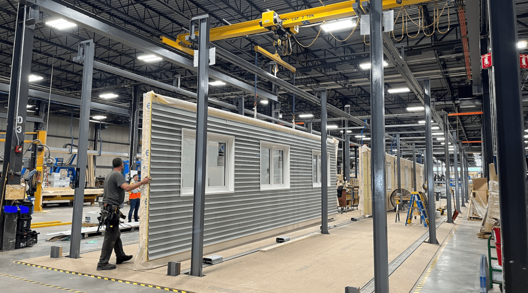 Assembling building panels in an off-site construction plant