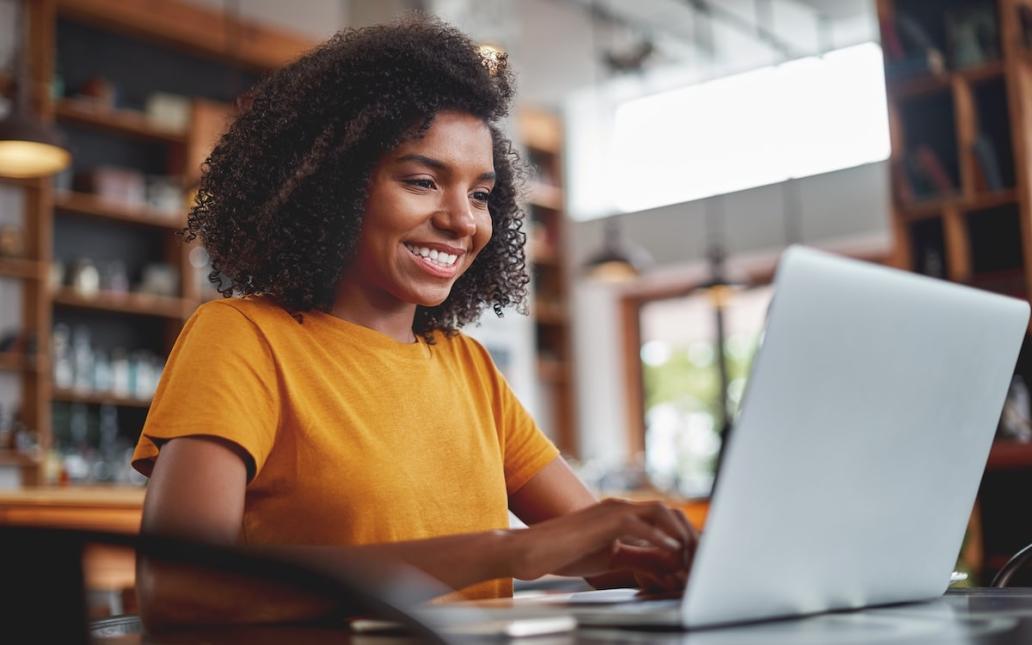 A woman applies for a scholarship on her laptop