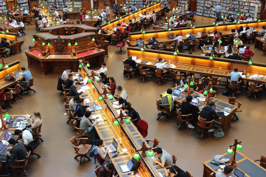 University library with rows of students working on laptops