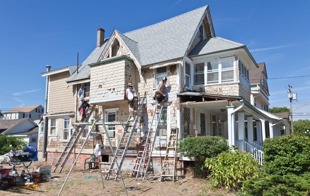 People remodeling exterior of beach house