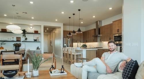 Interior designer Bobby Berk sitting in a Tri Pointe Homes model home