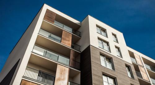 View looking up at outside of multifamily apartment building