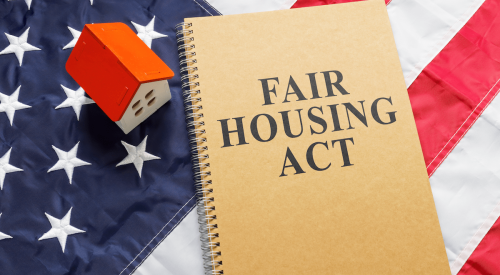 Fair Housing Act and model of a house with the American flag in the background