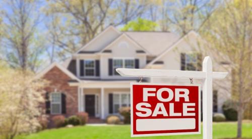 Single-family home with for-sale sign in front yard