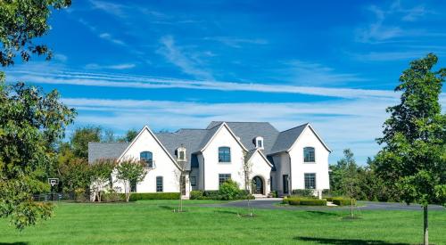 View of luxury single-family home from frontyard