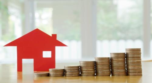 A red house sits next to a pile of coins, coins increase in value from left to right showing housing costs growing