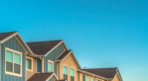 Row of townhomes against blue sky