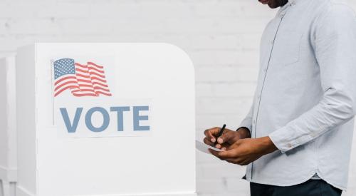 Voter approaches booth to fill out ballot