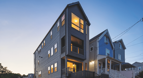 Exterior view of The Picket Fence  Idea Home from the street at dusk