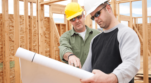 Builders with roll of house plans discuss how to make homes more affordable