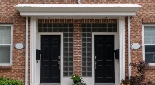 A closeup of two doors in a duplex