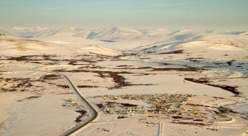 Aerial view of snow covered mountains and residential area on the outskirts of Nome, Alaska