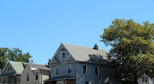 Row of houses against blue sky