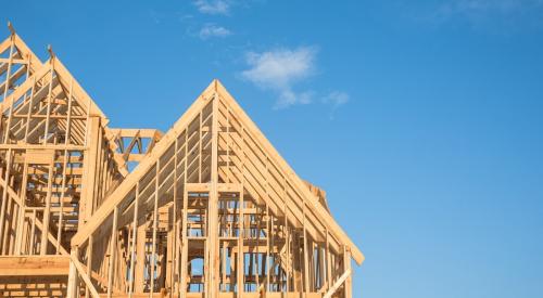 A framed single-family home against a blue sky 