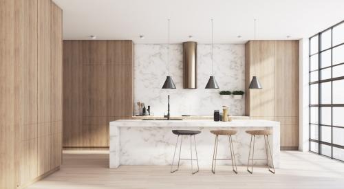 A newly renovated kitchen with a marble island in the center