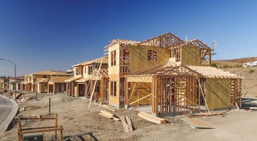 A row of single-family homes sits under construction