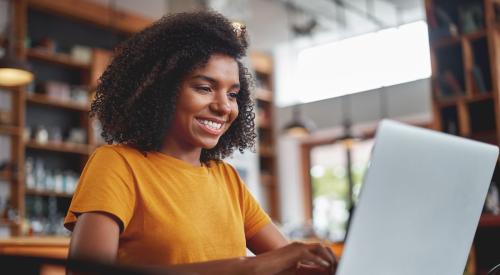 A woman applies for a scholarship on her laptop