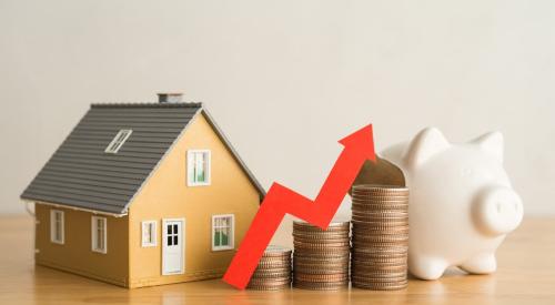 A model home and piggy bank sit next to three stacks of coins placed in ascending order from left to right, indicating financial growth